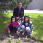 Children help plant the Children’s Garden, and receive a flower for mom.