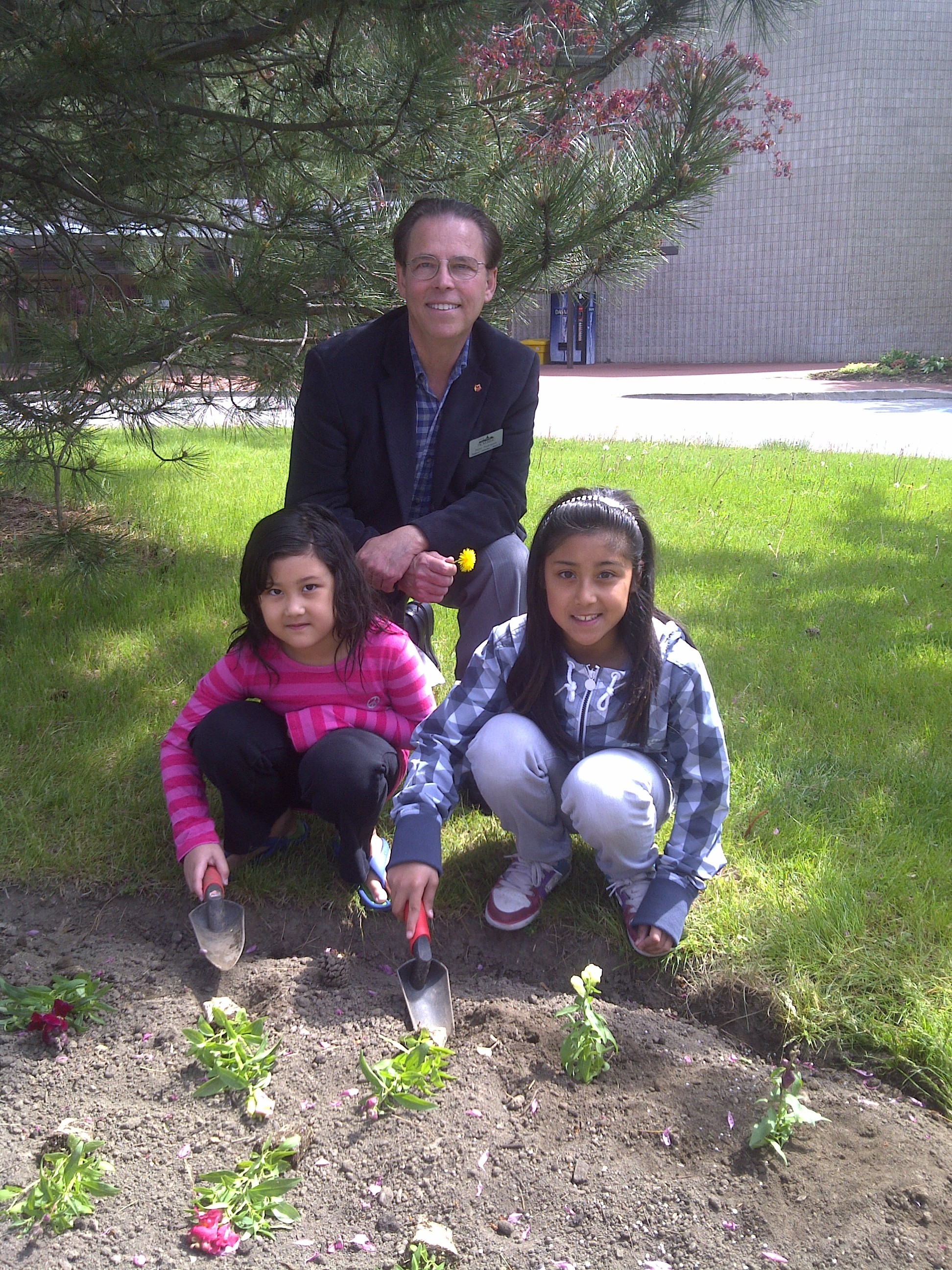 Children help plant the Children’s Garden, and receive a flower for mom.